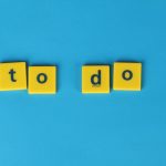 Yellow letter tiles spelling 'to do' against a vibrant blue background for organizational themes.